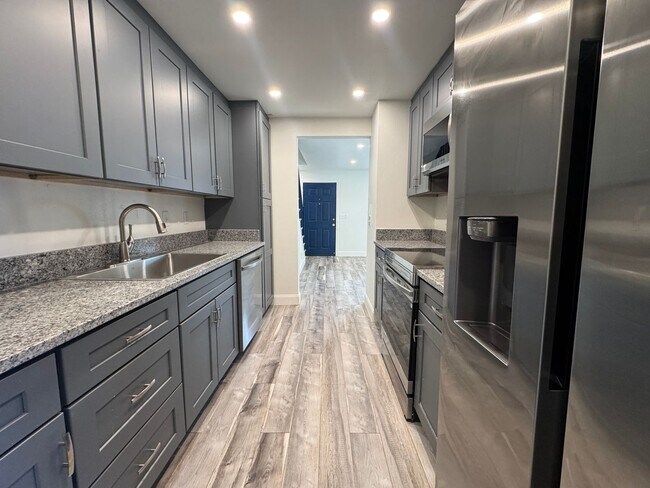 Building Photo - RENOVATED 3 bedroom end unit across the street from the Beach!