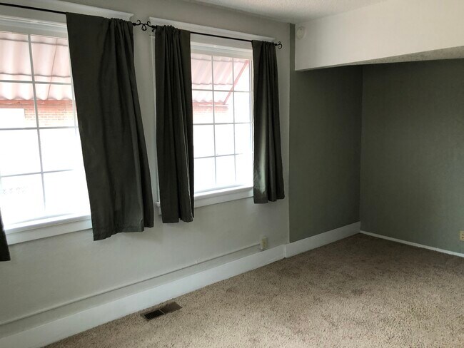 Bedroom with blackout curtains - 116 Polk St