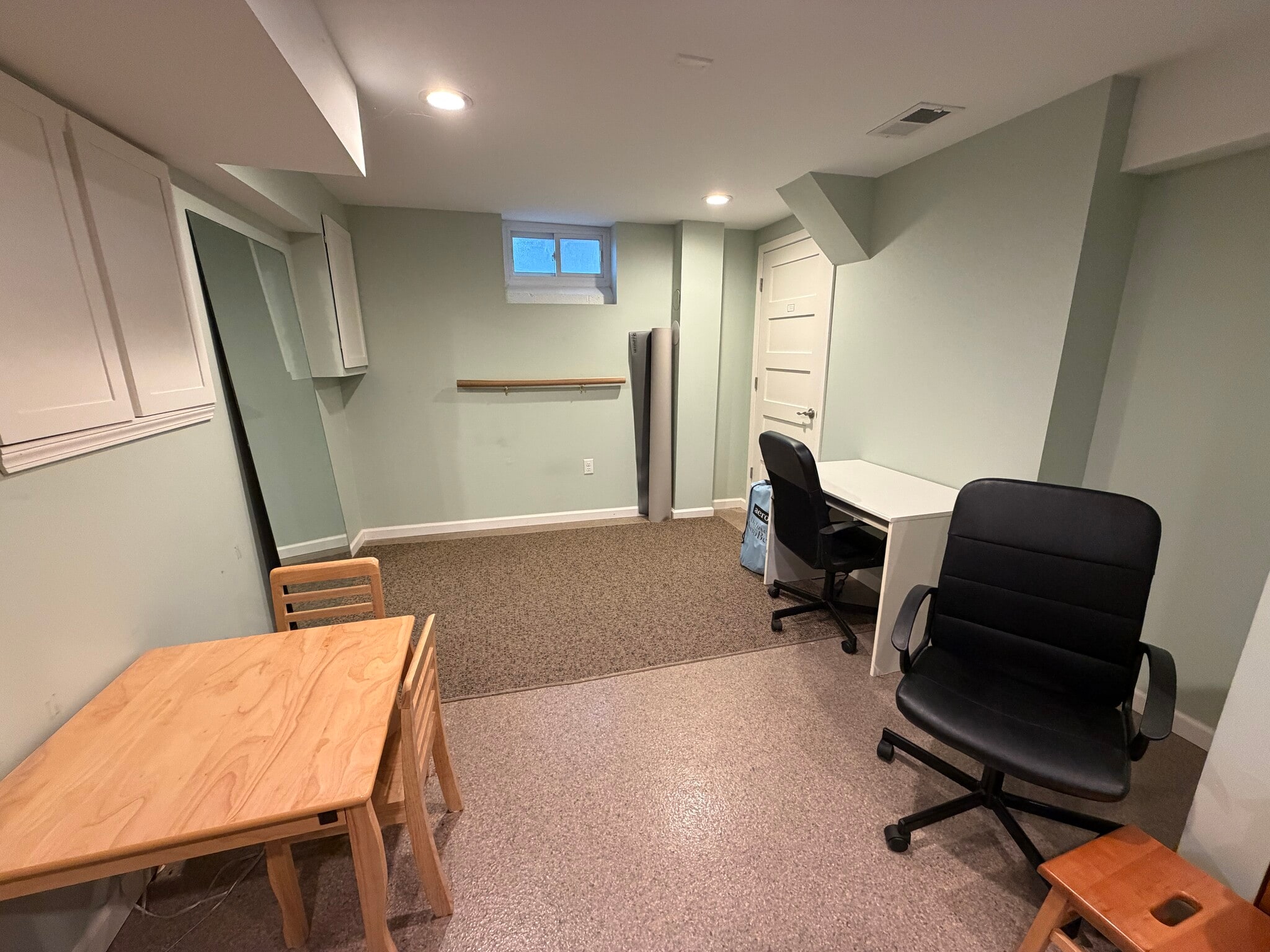 far end of living room w/desk and space for workout or air mattress; utility/storage room to right - 1622 Pear St