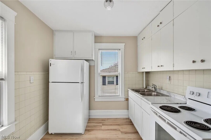 Kitchen with newer appliances and plenty of natural sun light. - 245 E Ford Ave