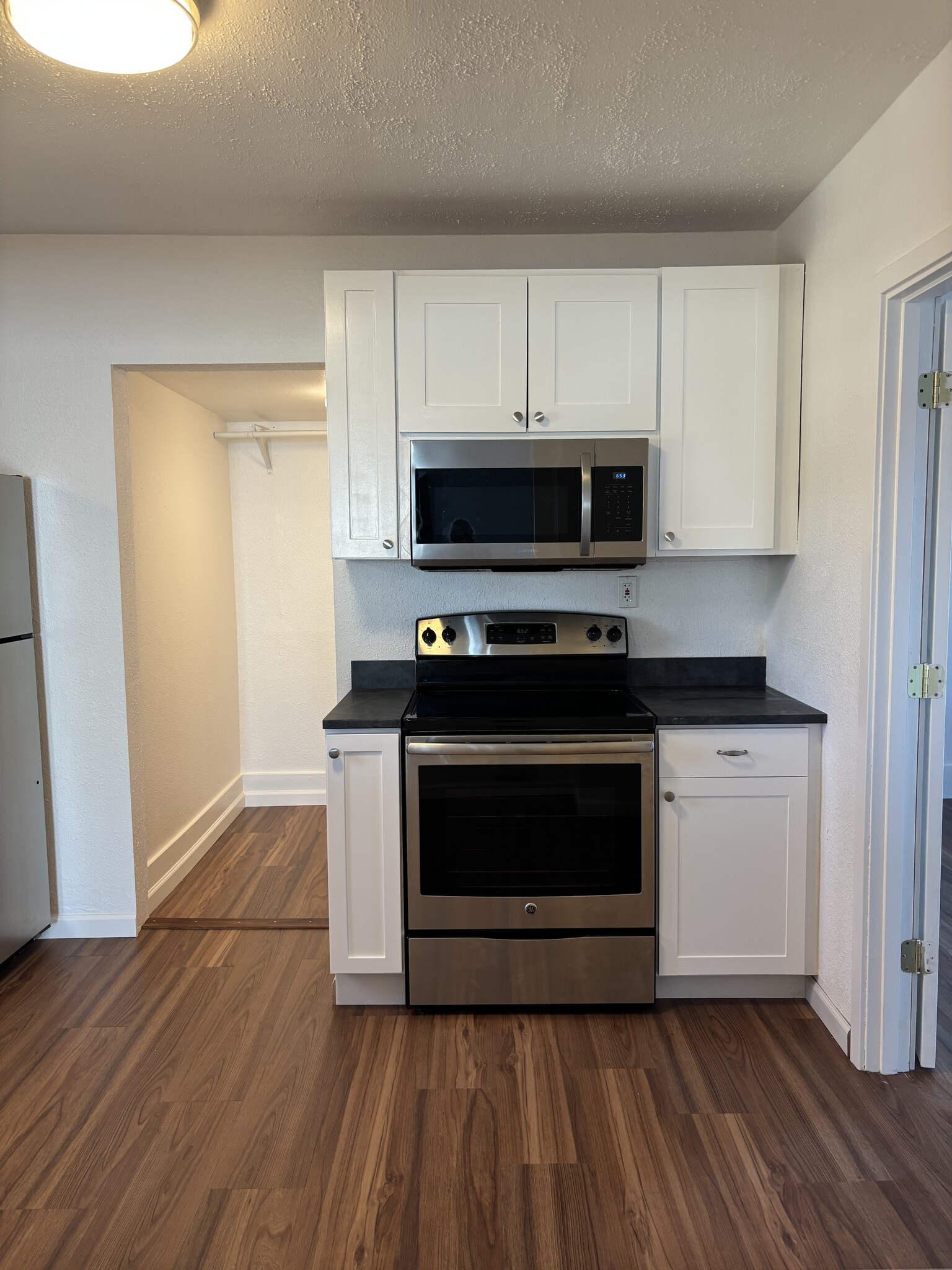 Newly refreshed kitchen with stainless steel appliances and white shaker style cabinetry - 1725 S 35th St