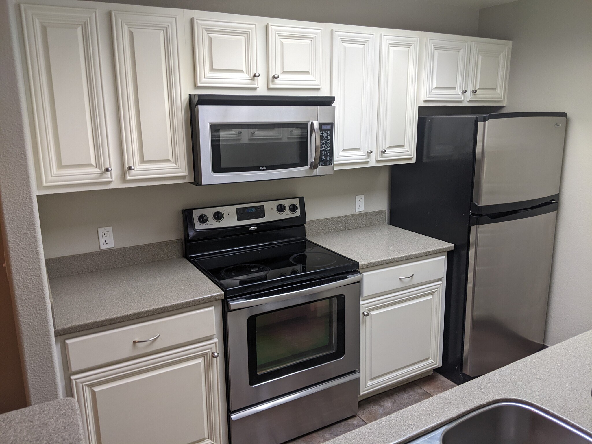 Stainless steel fridge and stove - 3830 E Lakewood Pky E