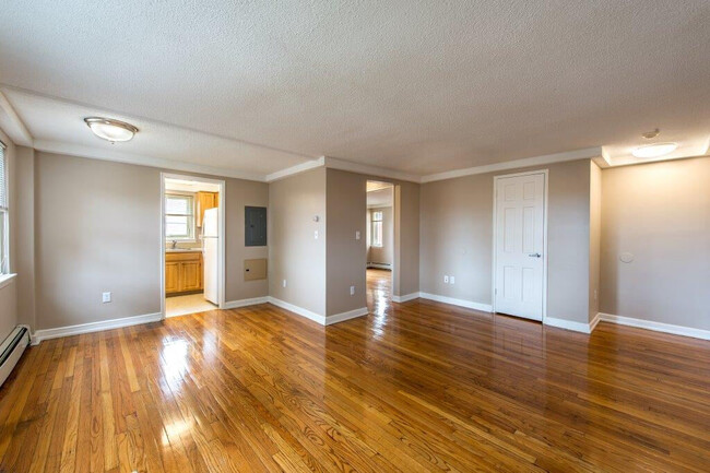 Wooden Floors in Beautiful Open Living Room - Forest Park Apartments