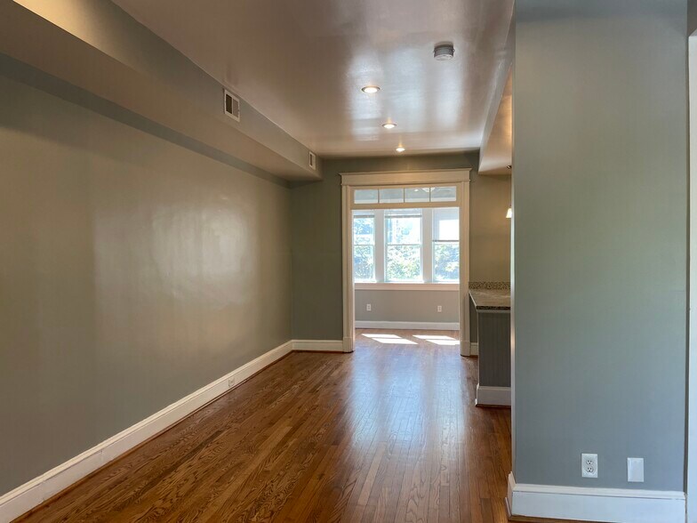View of the dining area looking back to the den and driveway. - 1110 4th St NE