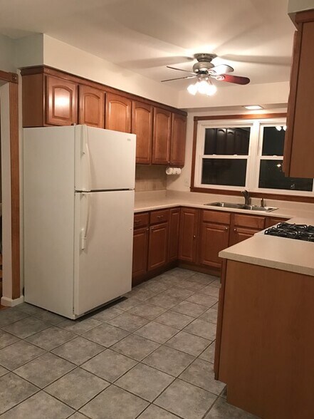 Kitchen with maple cabinets,ceramic floor and porcelain back splash. Appliances like new. - 726 Meacham Ave