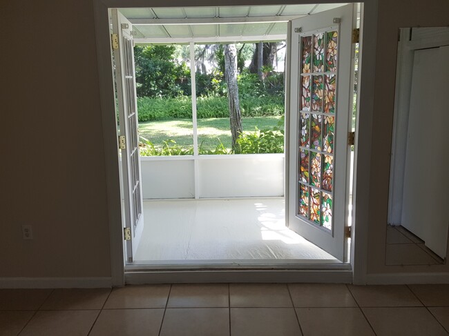 French doors leading from primary bedroom to backyard - 6906 Coach St