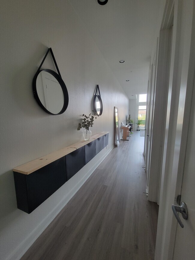 Long entry way with entry way closet and secondary bedroom to the right - 207 Pierce St