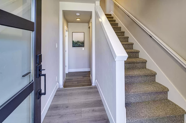 Hallway to primary suite on first level and stairs to second level - 20563 Gloucester Ln