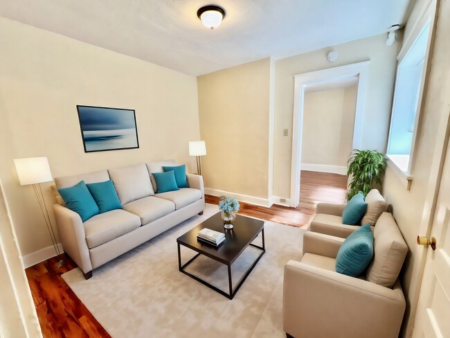 Step into a modern sanctuary boasting a stylish design with soothing colors and plush seating. - Cross Apartments