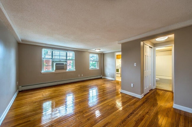 Wooden Floors in Beautiful Open Living Room - Forest Park Apartments