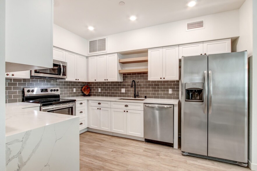 Fully-equipped kitchen with side by side refrigerator - Newhall Crossings