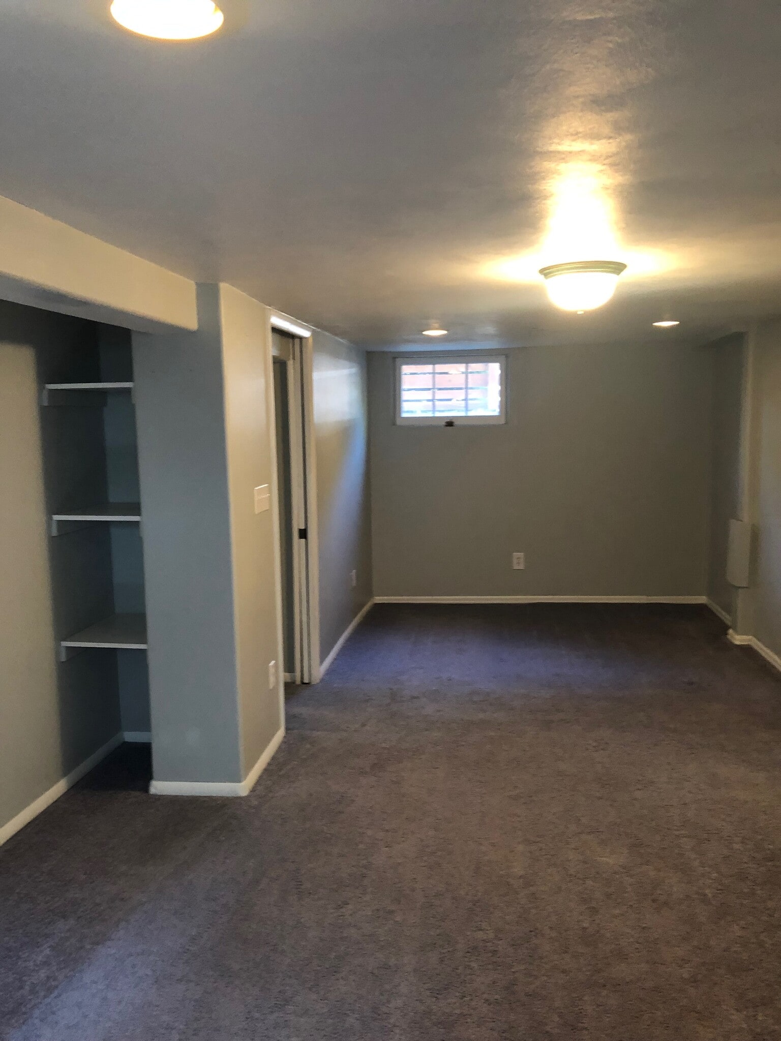 Bright N facing with view of hallway and storage shelves - 4155 N Raleigh St