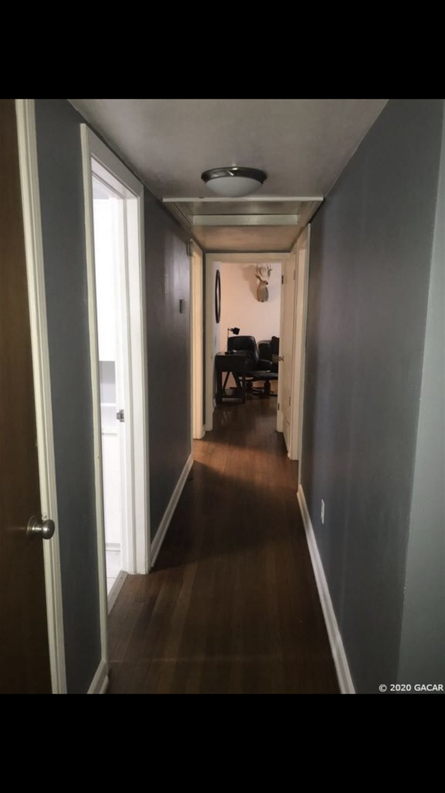 Hallway with storage closets - 3125 W University Ave