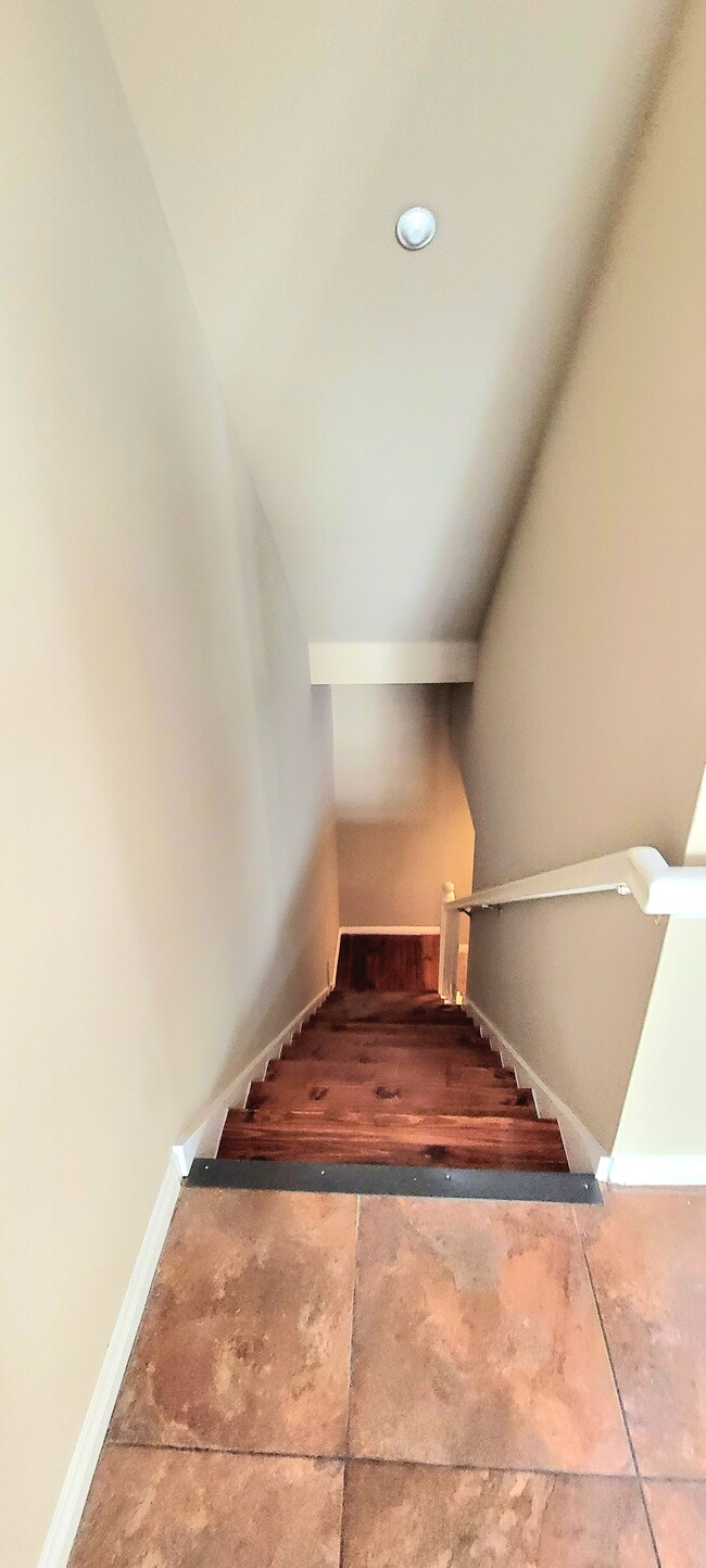 Stairs leading from first floor to garage level - 9254 Elm Vista Dr