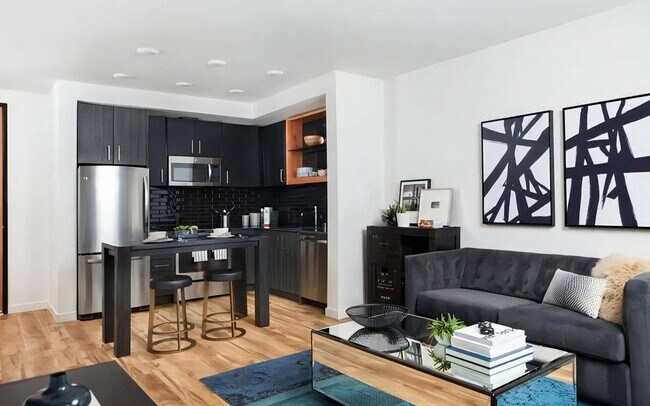 Shared Living Space Featuring Lounge, Kitchen Island, and Dining Zone - Pike Motorworks