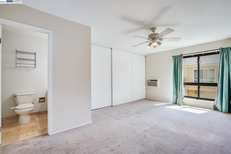 Primary bedroom with full closet - now has wooden flooring - 9005 Alcosta Blvd