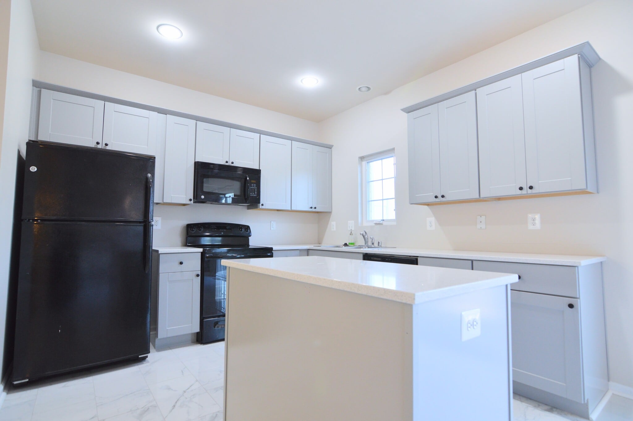 Kitchen with refrigerator, microwave, electric stove/oven and dishwasher - 11696 Palm Desert Pl