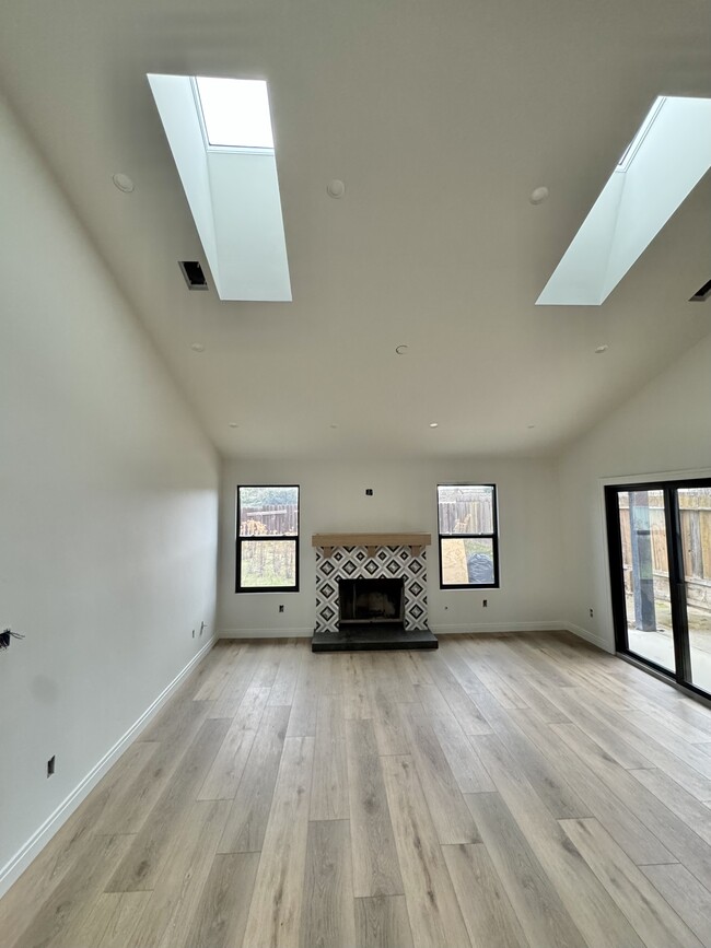 vaulted living room with new fireplace and skylights - 269 Adobe Creek Ln