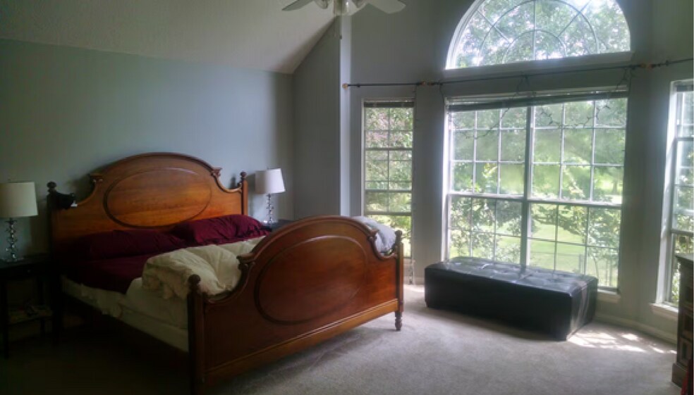 Spacious primary suite offers warm luxury with a private terrace, inviting fireplace, walk-in closet - 10913 Alexandria Dr