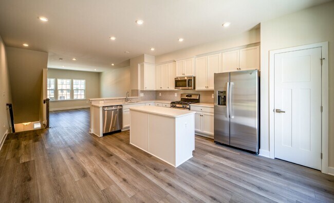 Building Photo - This 3-bedroom, 3-full bathroom townhouse offers a pristine and contemporary living experience.
