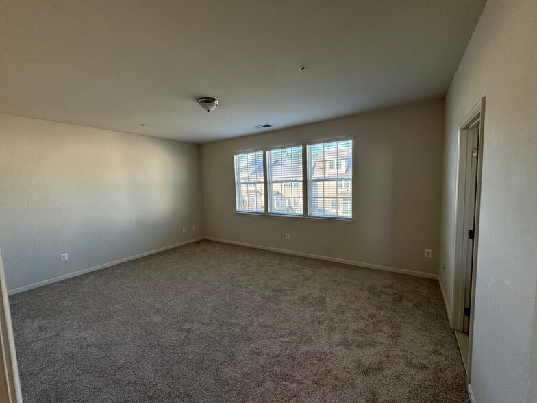 Welcome to the huge primary bedroom in the rear of the townhome...with TWO walk-in closets! - 44520 Gray Wolf St