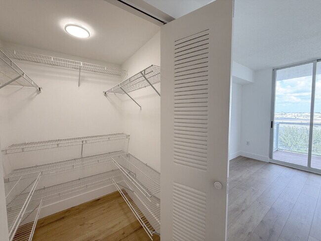 Building Photo - Rare 2/2 Corner Penthouse with Panoramic Lagoon Views from Every Room – Available Now!