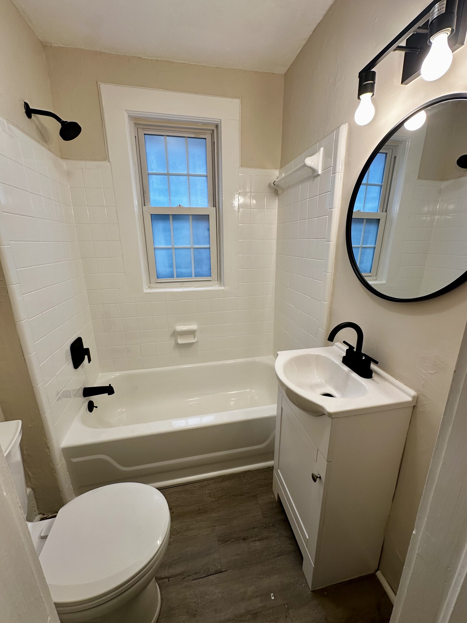 Refreshed bathroom with new toilet, vanity, fixtures, and refinished shower and tub - 2521 Longview Ave SW