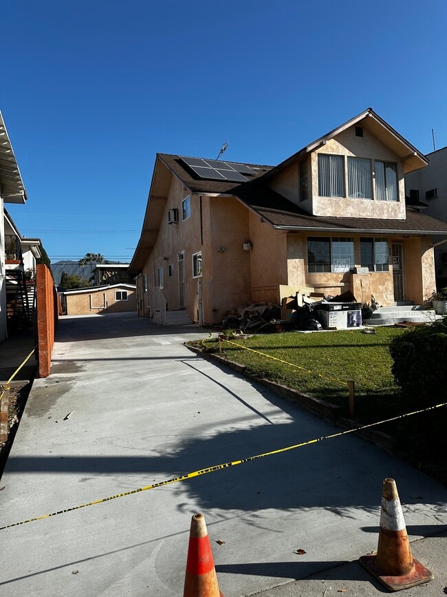 Exterior fences and walls in process of being painted - 349 W Lomita Ave