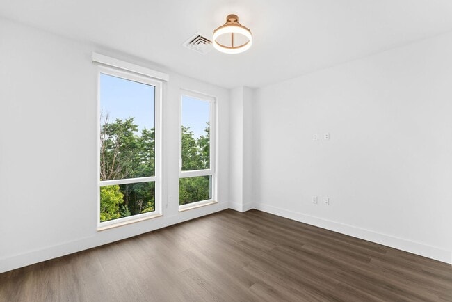 Building Photo - 2 Bedroom Corner-Unit with Wooded Balcony ...