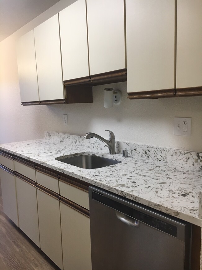 Kitchen features dishwasher and garbage disposal - Mona Lisa Apartments