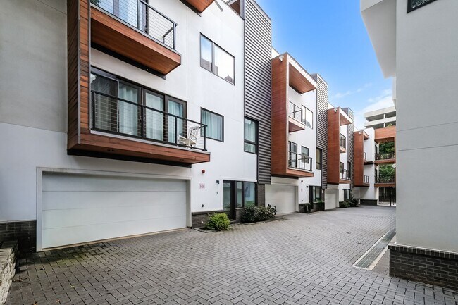 Building Photo - 50% OFF APPLICATION FEE! Sleek 2BR Townhome-Style Condo with Rooftop Deck