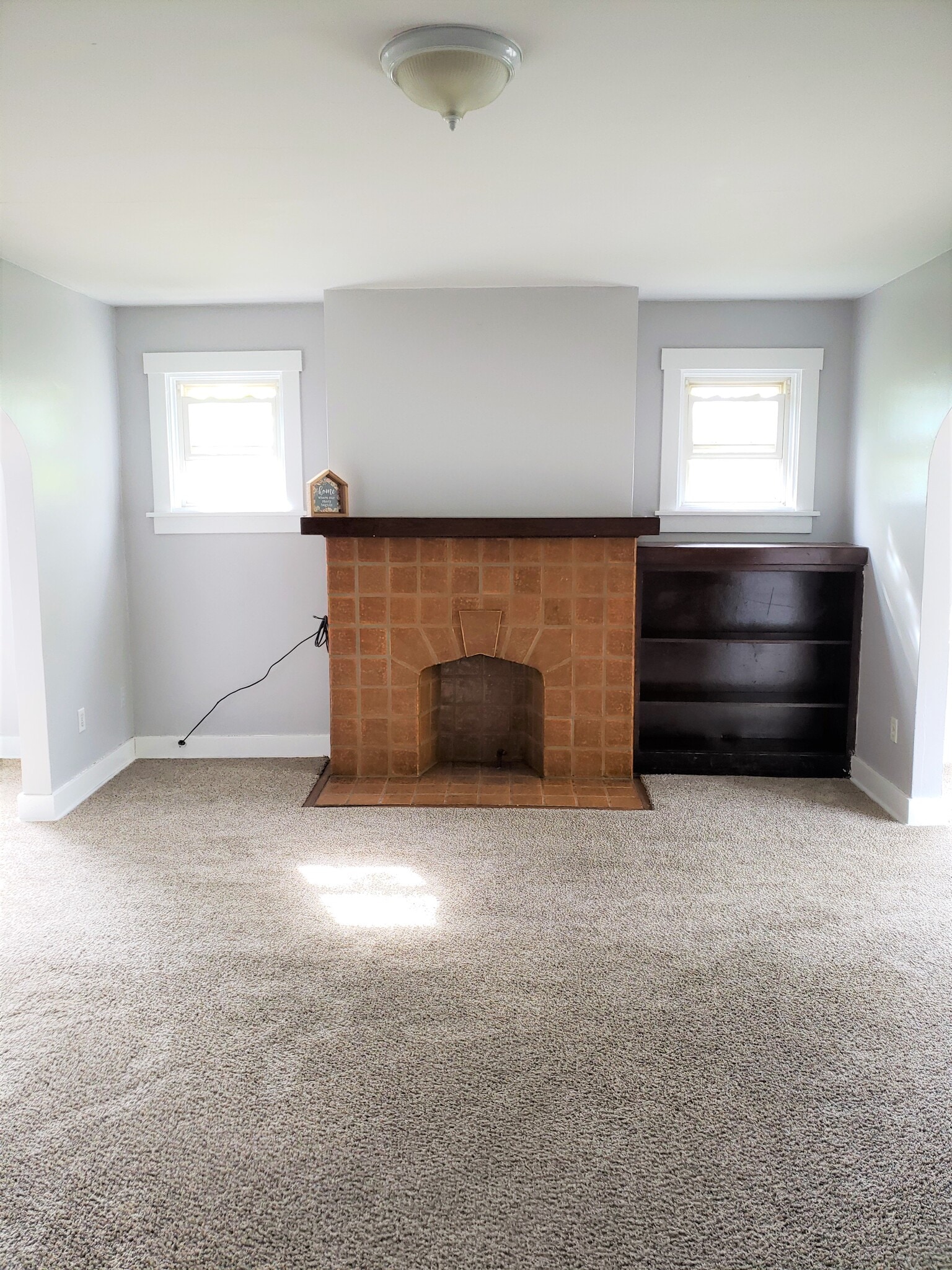 The cosmetic fireplace with built in book shelves adorn the living room - 201 Richbarn Rd
