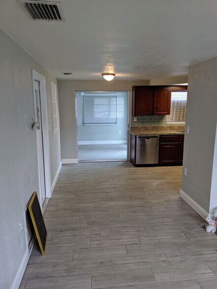 Open view from living area into kitchen with dishwasher - 1147 Jennings Dr