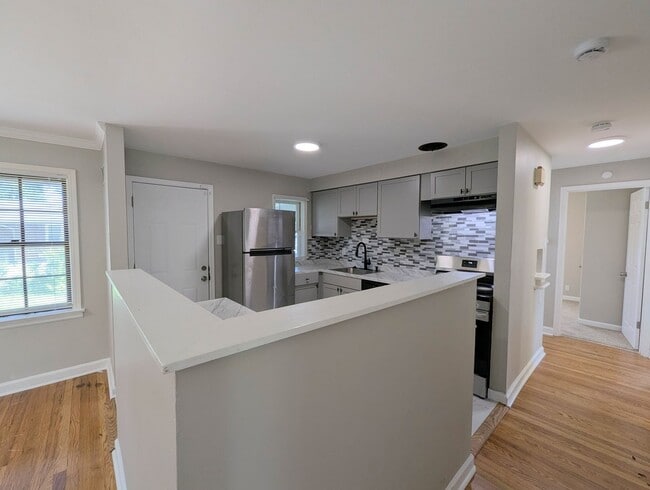 Building Photo - Updated Open-Concept with Sunroom & Finished Basement Space