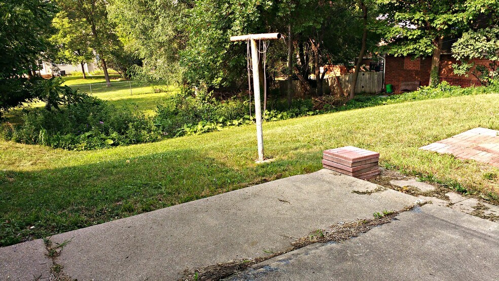 The backyard extends down the hill to the fence, but is not fenced on the two sides. - 1624 elmhurst ave