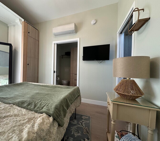 Bedroom 2 with its own Euro-style heater/ac unit mounted near ceiling - 1490 Ash St