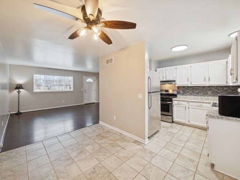 From left to right: living room, dining room, kitchen - 8204 Toepfer Rd