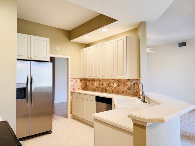 Building Photo - Experience Bell Tower Park. GATED ground floor 2 Bed 2 Bath Den 1 Car Garage Condo.