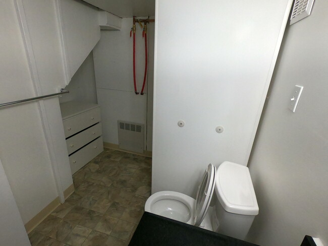 The private bathroom has plenty of storage. - 303 Hanover St