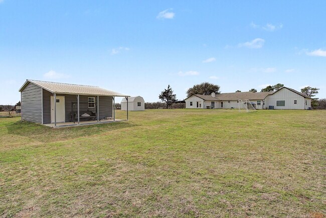 Building Photo - “Farmhouse Charm Meets Modern Luxury on a Serene 5-Acre Lot!”