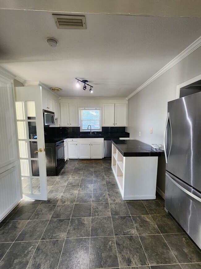 Building Photo - Spacious 4BR/2BA Brick Home with Fireplace, Large Island!
