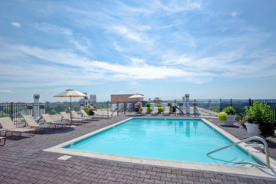 Rooftop pool and sundeck with lounge seating - Avalon at Foxhall