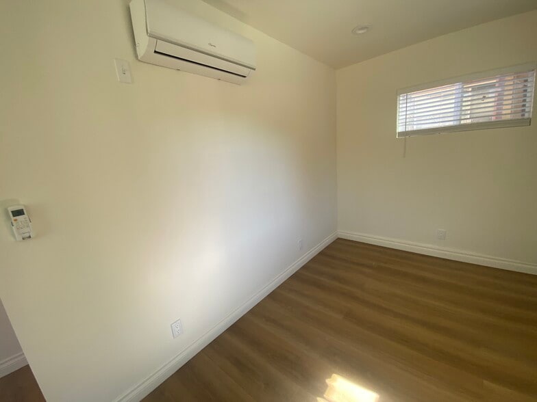 AC unit Provided. Living room or dining area - 2425 N Parish Pl