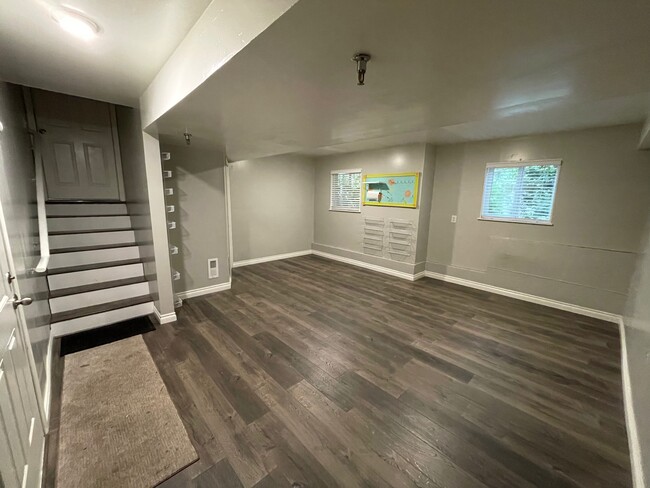 Spacious finished bonus room in basement ready for games, exercise, or crafts - 13400 Dumas Rd