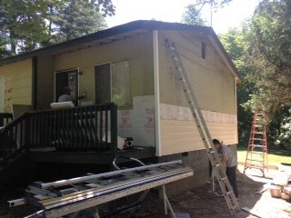 The contractors are had at work installing the new siding on the house - 2680 Ballsville Road