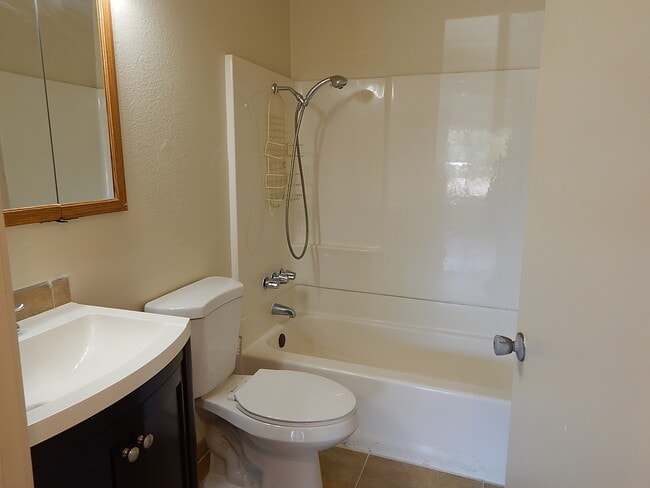 Building Photo - This property is a 3 bedroom, 2 bathroom home featuring an open floor plan with tile throughout. ...