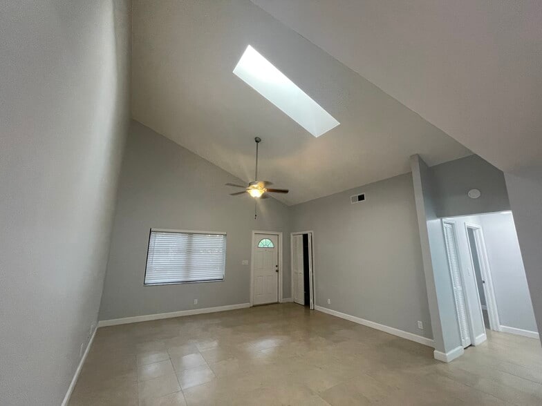 Living area with vaulted ceilings and skylight - 2051 Cove Ln