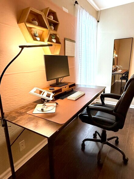work from home set up with extended desk, ergonomic chair, desk light, and 24" monitor - 9163 Timber Rnch