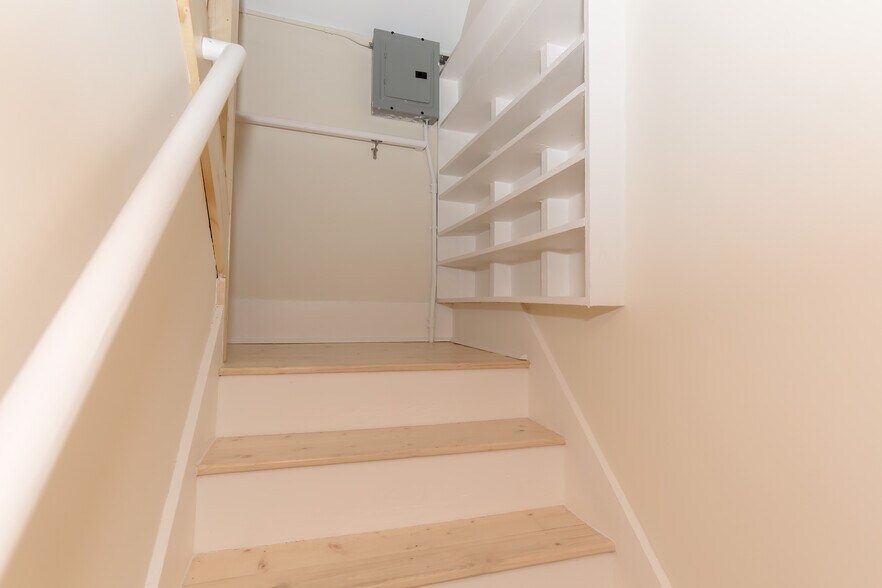Staircase to upper floor of apartments with shelves for footwear - 715 5th St SE