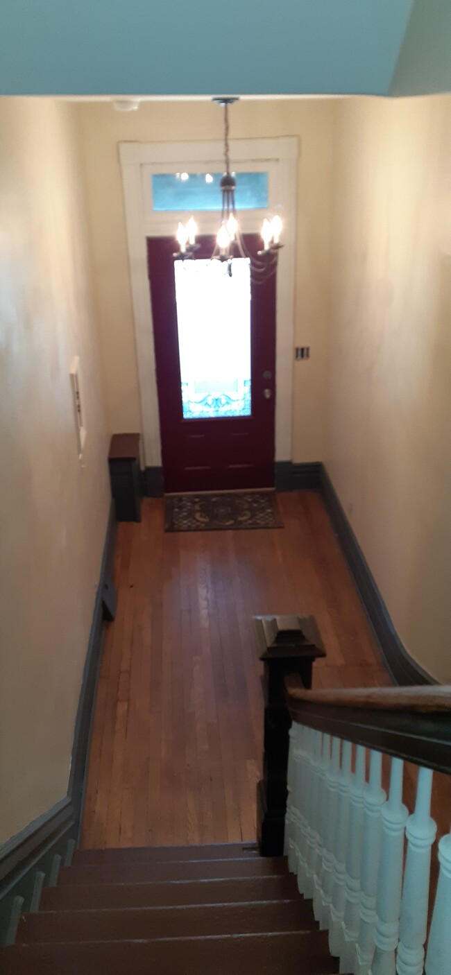 view of entry door from stairway form 2nd to 1st floor - 7718 Brashear St